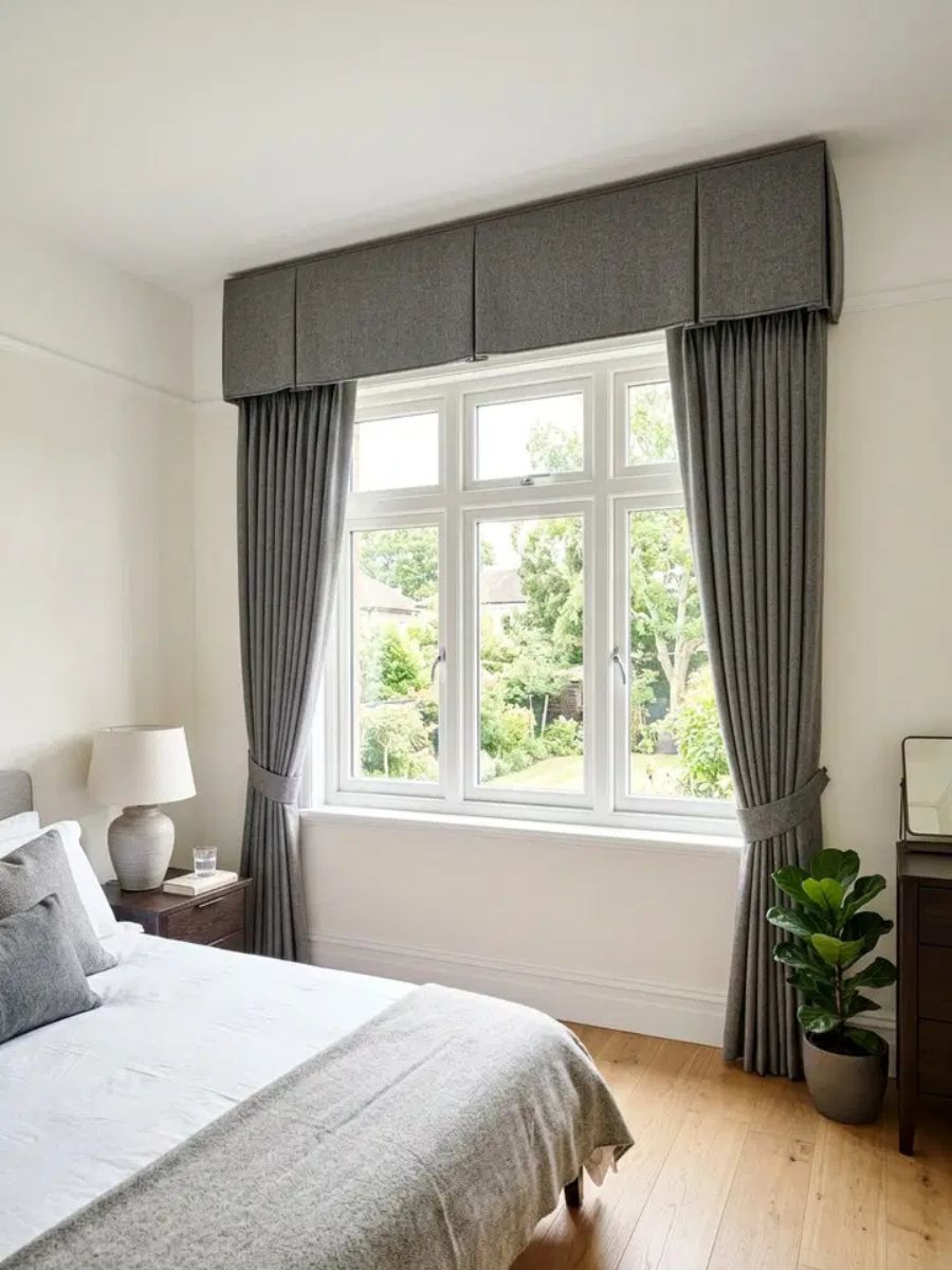 Structured wool valance at the top of a bedroom window adding a polished finish